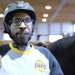 Man participating in therapeutic horseback riding