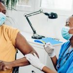 Man receiving covid-19 vaccine